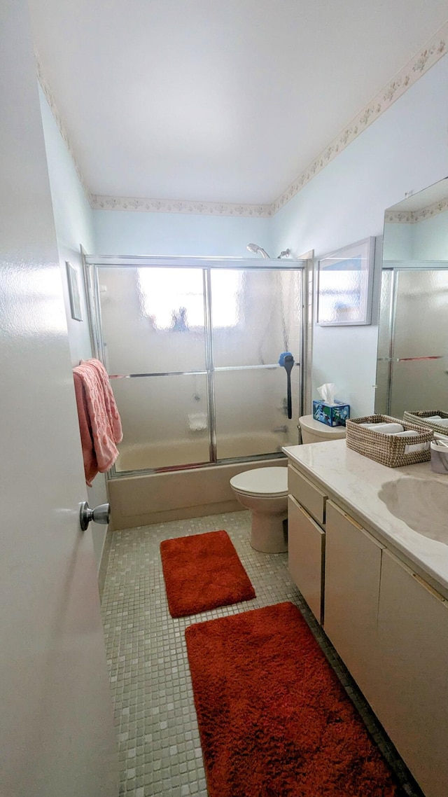 full bathroom with shower / bath combination with glass door, vanity, and toilet