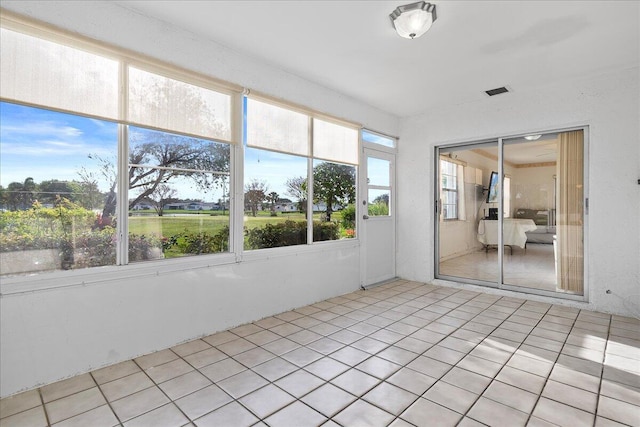 unfurnished sunroom featuring visible vents