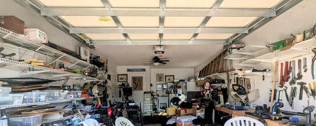 garage with a garage door opener and ceiling fan