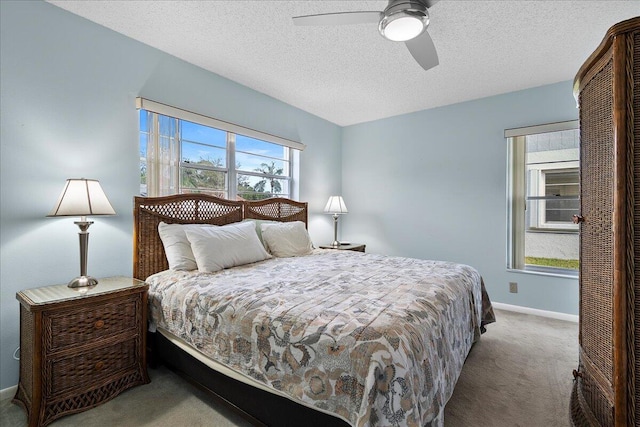 bedroom featuring a textured ceiling, ceiling fan, carpet flooring, and baseboards