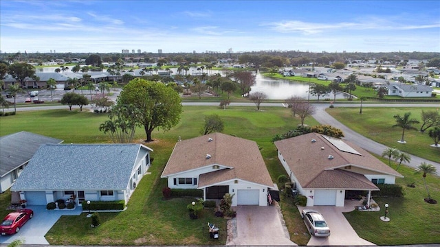 drone / aerial view featuring a water view and a residential view