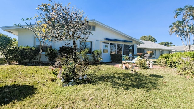 back of house featuring a yard and a patio area