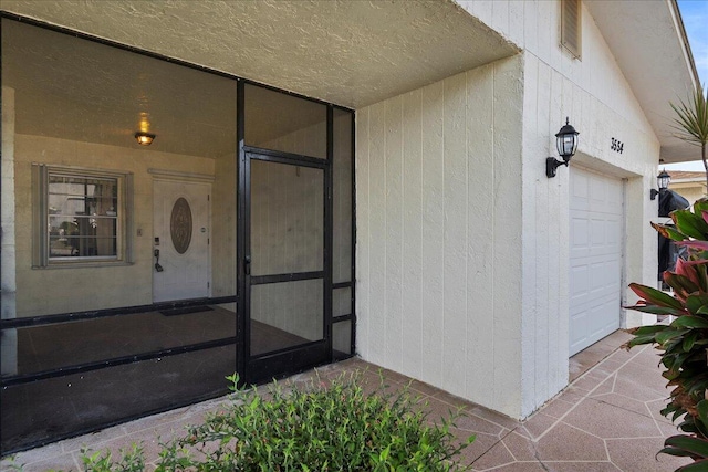 doorway to property featuring an attached garage