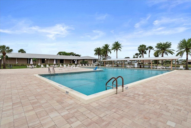 pool featuring a patio and fence