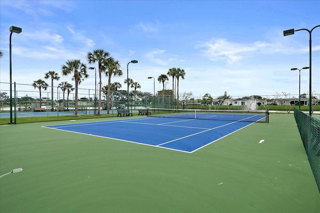 view of sport court featuring fence