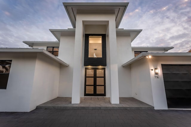 exterior entry at dusk with a garage