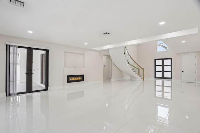 unfurnished living room featuring french doors