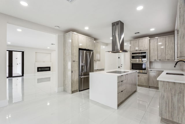 kitchen with appliances with stainless steel finishes, a center island, sink, island range hood, and light tile patterned flooring