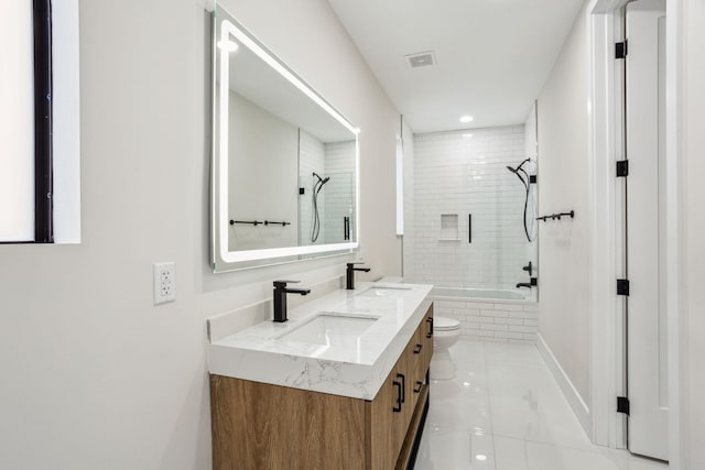 full bathroom featuring toilet, tiled shower / bath combo, tile patterned flooring, and vanity