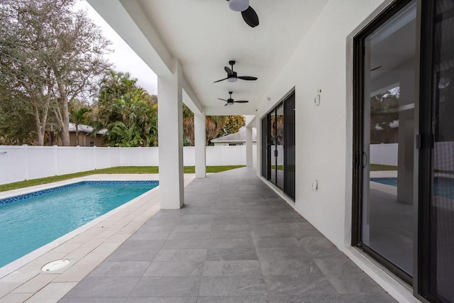 view of pool with ceiling fan and a patio