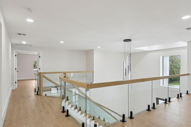 hallway with light hardwood / wood-style flooring