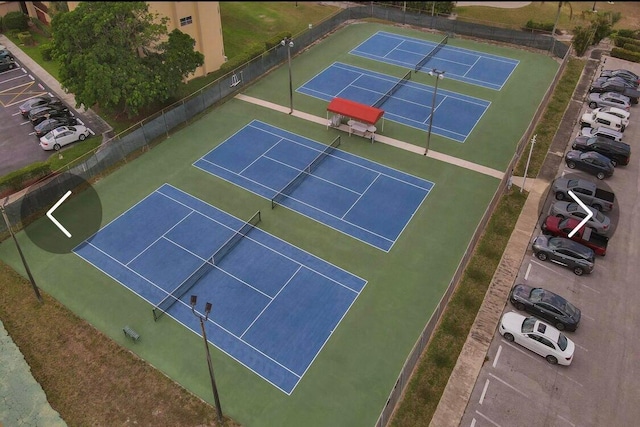 view of tennis court featuring basketball hoop