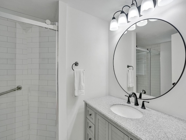 bathroom with walk in shower and vanity