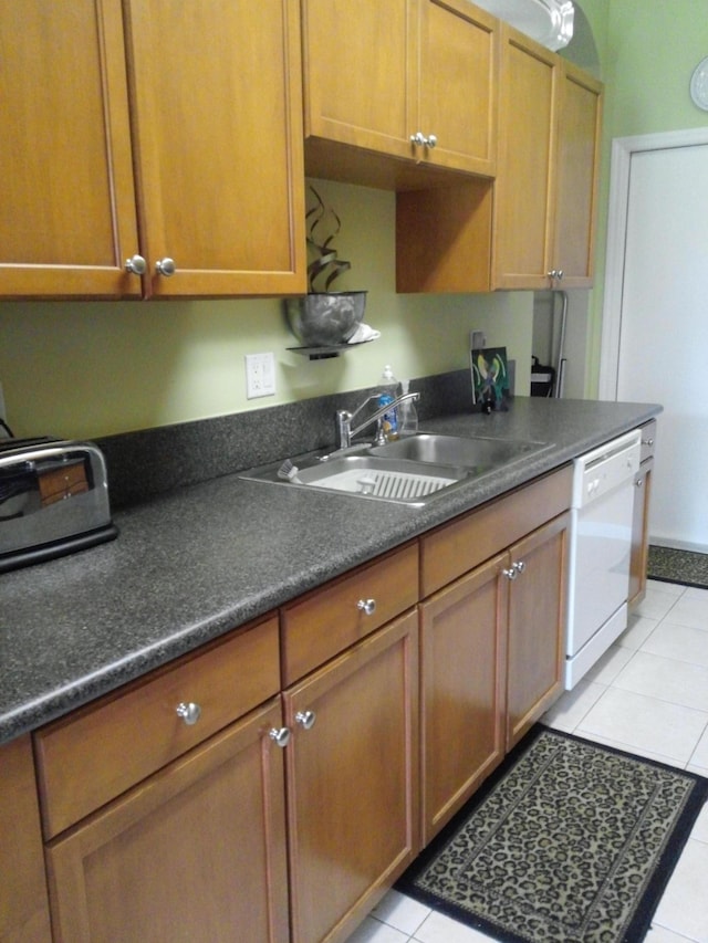 kitchen featuring dishwasher, light tile patterned floors, and sink