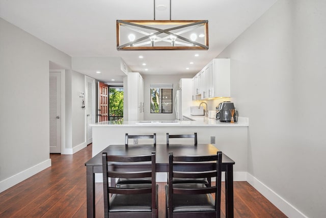 dining room featuring dark hardwood / wood-style floors and sink