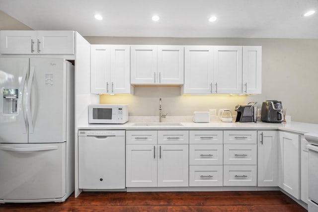 kitchen with dark hardwood / wood-style flooring, white appliances, white cabinetry, and sink