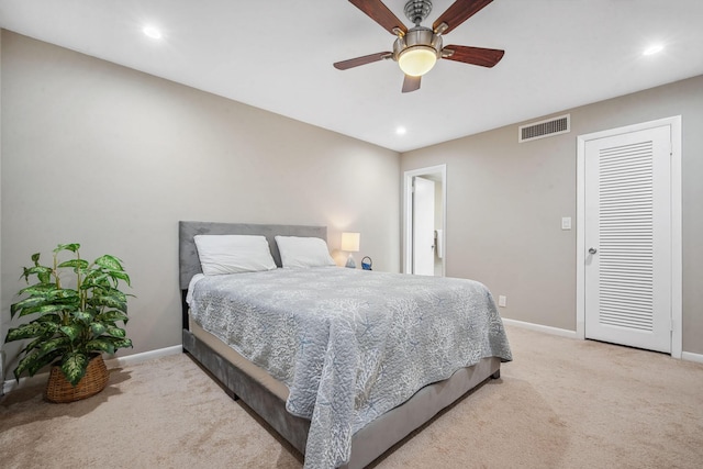 bedroom with ceiling fan and light colored carpet