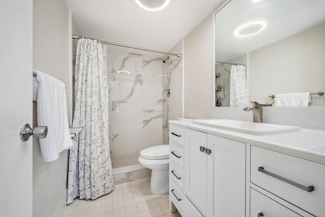 bathroom featuring tile patterned floors, curtained shower, vanity, and toilet