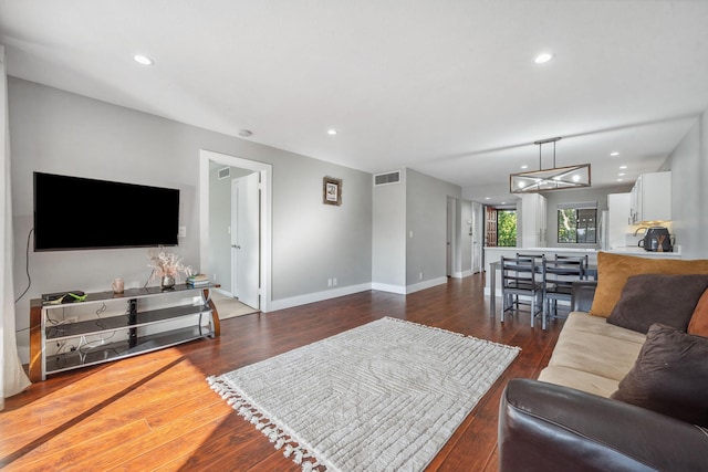 living room featuring dark wood-type flooring