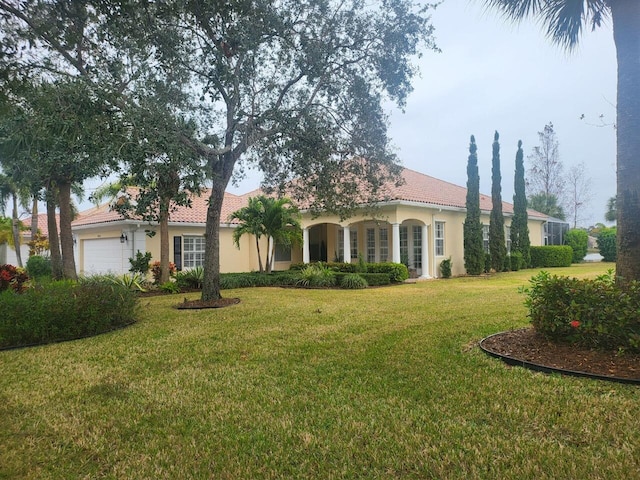 view of front of property featuring a front lawn and a garage