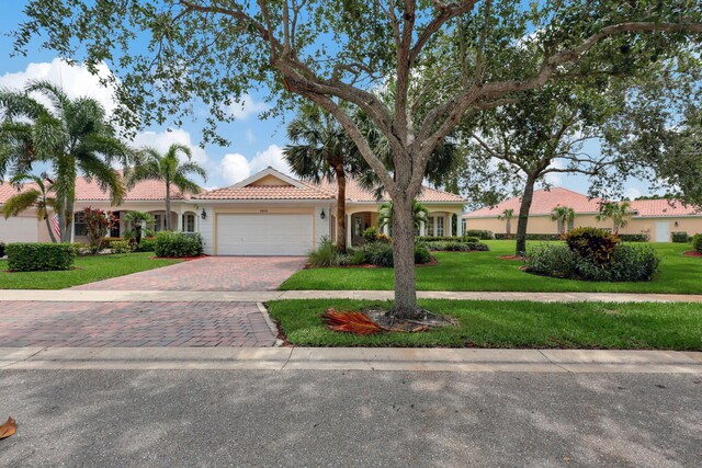 view of front of property featuring a garage and a front lawn