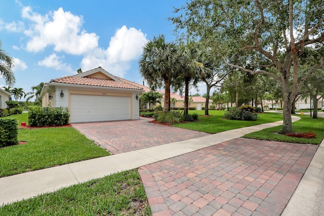 view of front of house featuring a garage and a front lawn