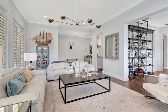 living room with wood-type flooring, ornamental molding, and a wealth of natural light