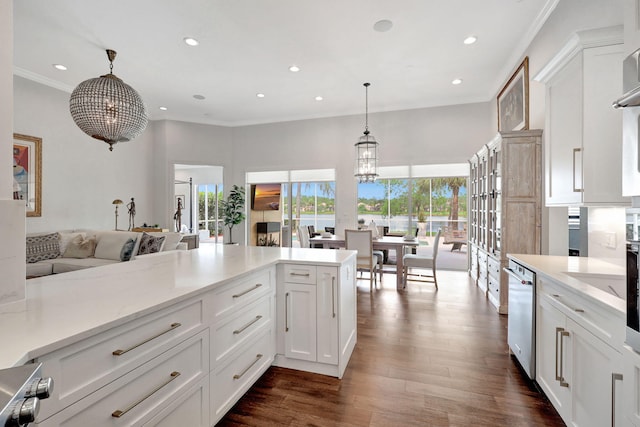 kitchen featuring a notable chandelier, dark hardwood / wood-style flooring, pendant lighting, white cabinets, and light stone counters