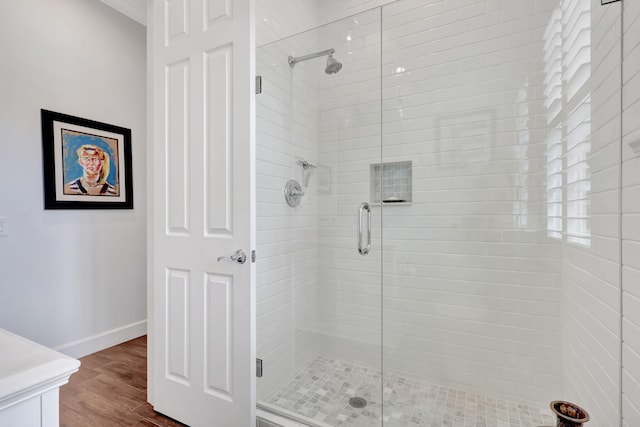 bathroom with hardwood / wood-style flooring and a shower with door