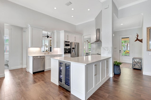 kitchen featuring tasteful backsplash, dark hardwood / wood-style flooring, beverage cooler, white cabinets, and black appliances