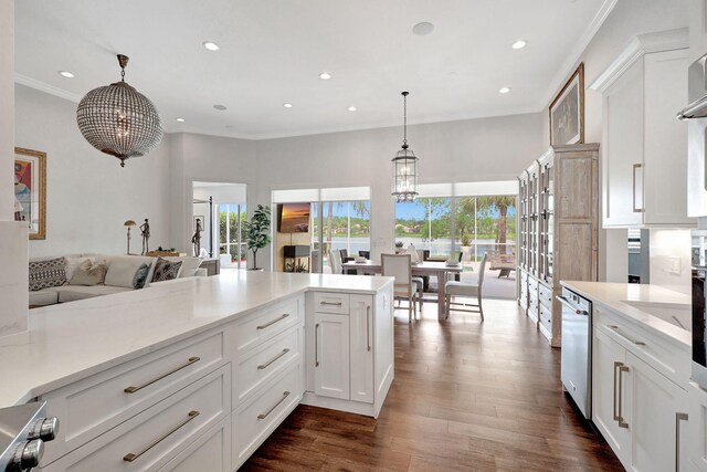 dining room with dark wood-type flooring, a chandelier, and sink