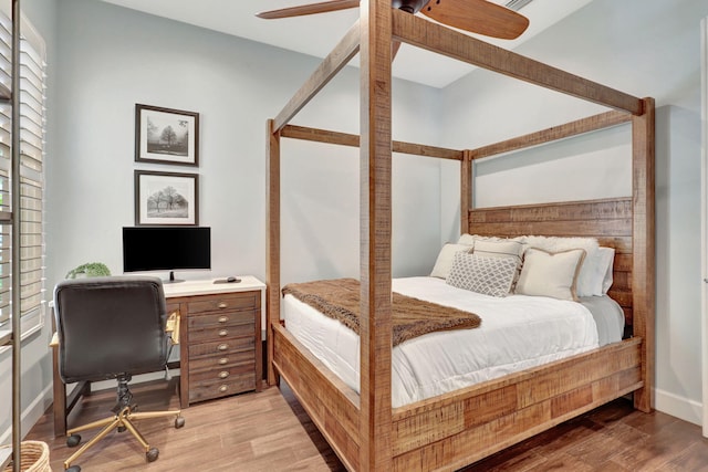 bedroom with ceiling fan and hardwood / wood-style flooring