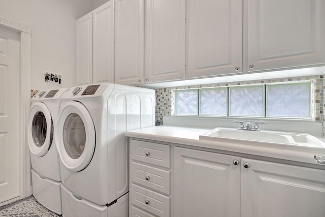 washroom featuring independent washer and dryer and cabinets