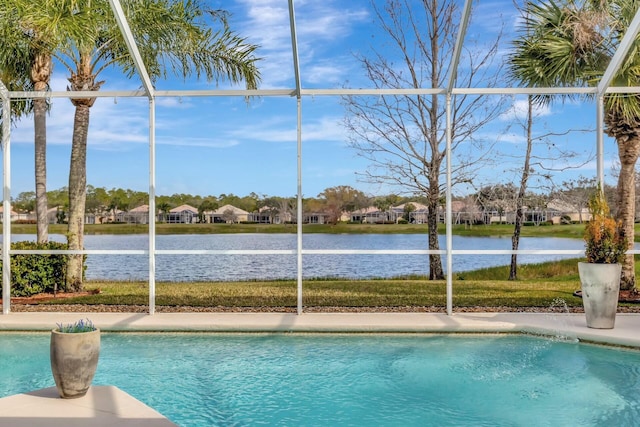 view of pool featuring a water view and glass enclosure