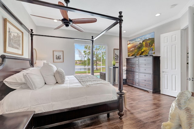 bedroom featuring ceiling fan, ornamental molding, and dark hardwood / wood-style floors