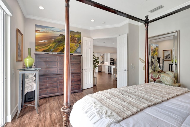 bedroom featuring crown molding and dark hardwood / wood-style floors