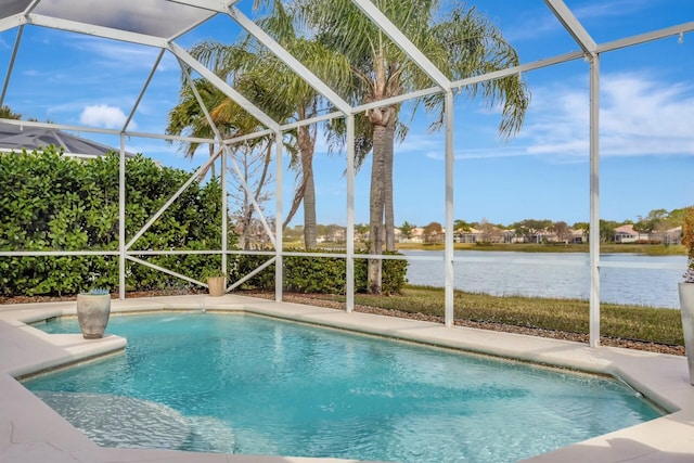 view of swimming pool featuring a water view, a patio, and a lanai