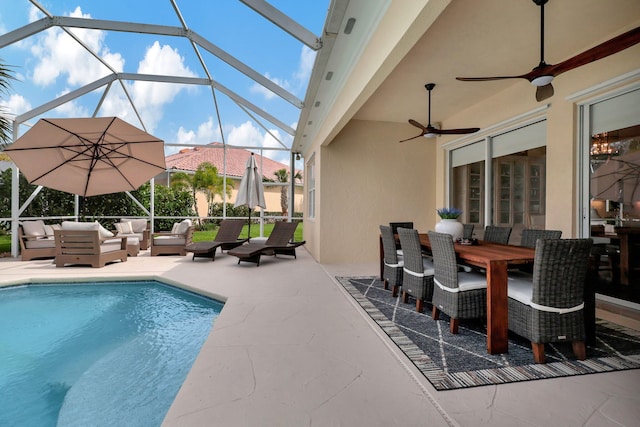 view of swimming pool with ceiling fan, a patio area, outdoor lounge area, and glass enclosure