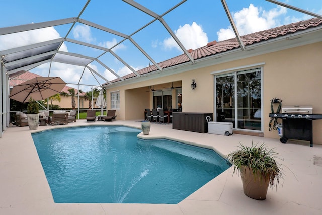 view of swimming pool with glass enclosure, a patio area, ceiling fan, and an outdoor hangout area