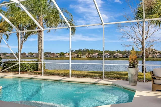 view of pool with a patio, a water view, and glass enclosure