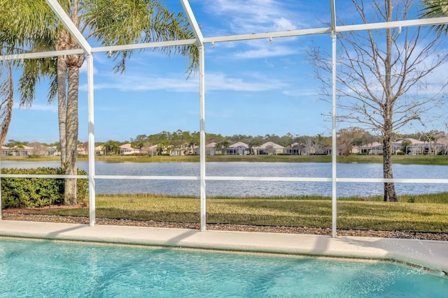 view of swimming pool with a lanai and a water view