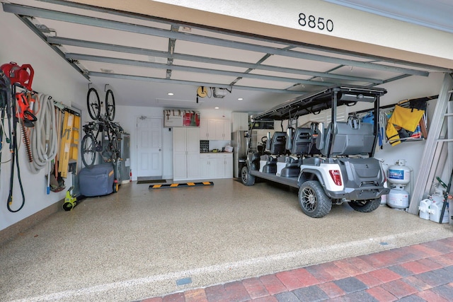 garage featuring water heater and a garage door opener