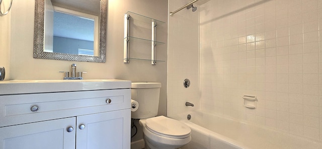 full bathroom with toilet, vanity, and tiled shower / bath