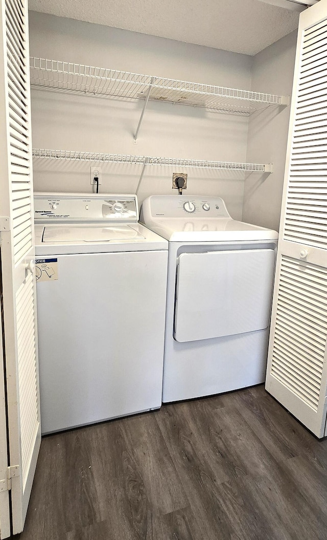 washroom with washer and dryer and dark hardwood / wood-style flooring