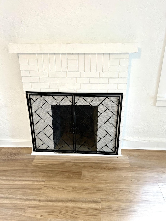 room details featuring a fireplace and wood-type flooring