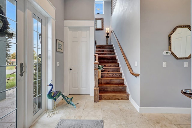 entryway with light tile patterned flooring