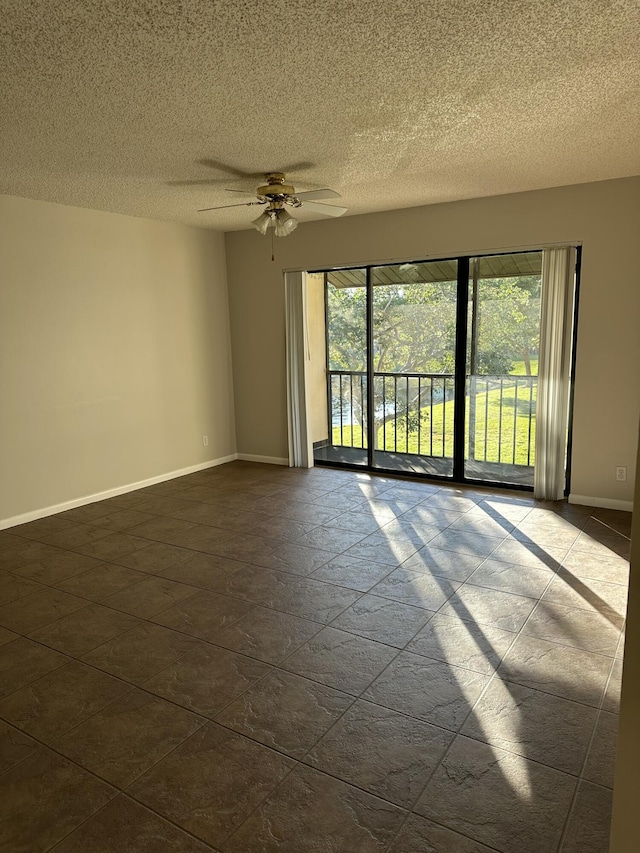 spare room featuring a textured ceiling and ceiling fan