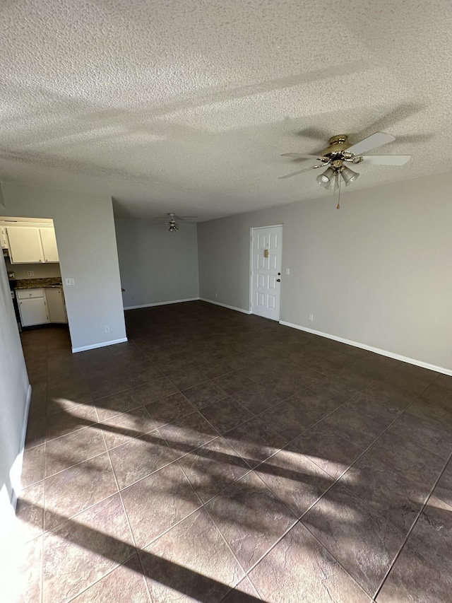 spare room featuring ceiling fan and a textured ceiling