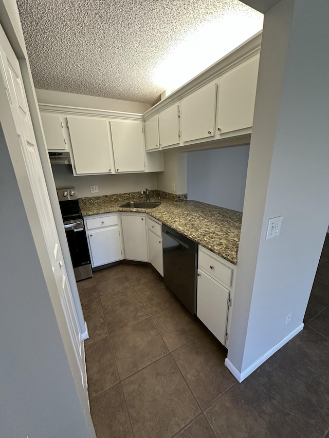 kitchen featuring dishwasher, sink, stainless steel range with electric cooktop, and dark stone counters