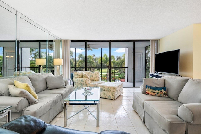 living room featuring light tile patterned floors, a wall of windows, and a textured ceiling